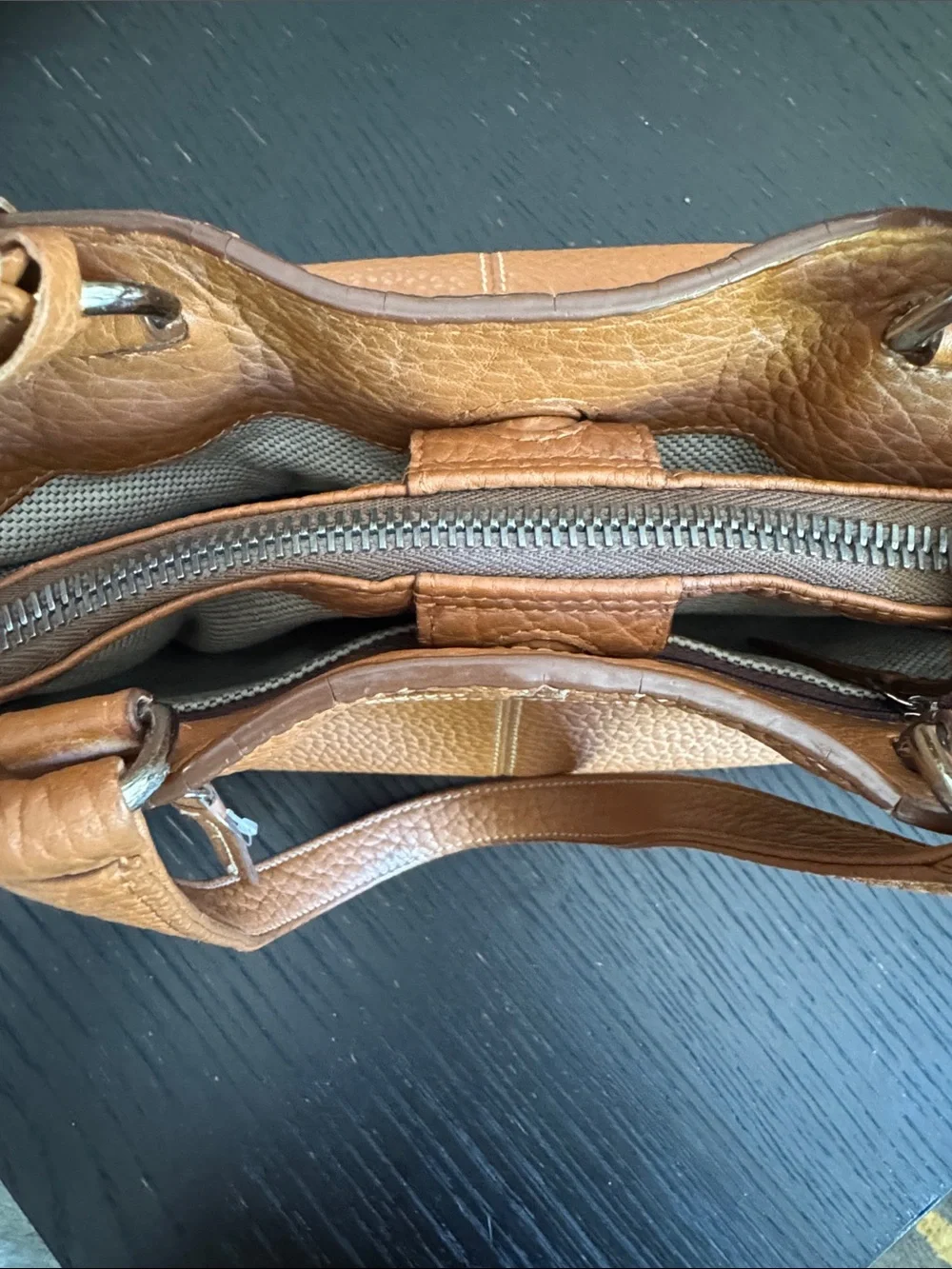 Dooney & Bourke tan pebbled leather side pockets belted satchel bag.